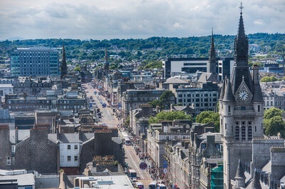 Aerial shot of Union Street in Aberdeen with a church spire in the foreground