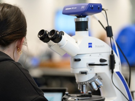 A woman at a microscope