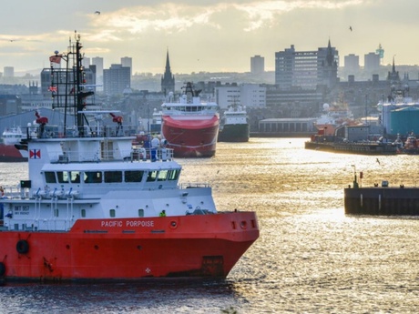 Aberdeen harbour with ships in the foreground and the city scape behind