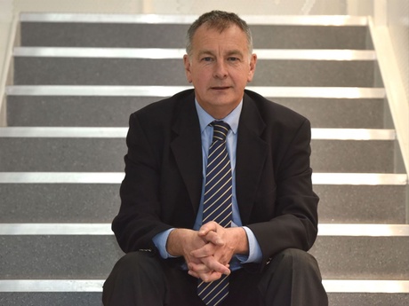 Professor Underhill sitting on a flight of stairs