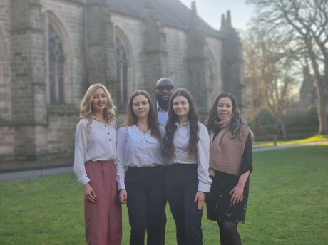 The team of four standing on the lawn at the Old Aberdeen campus with their coach