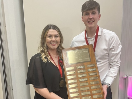 Ailsa Gardyne and Callum Leeson holding their winner's trophy