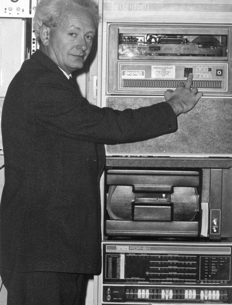 John Mallard next to an early computer