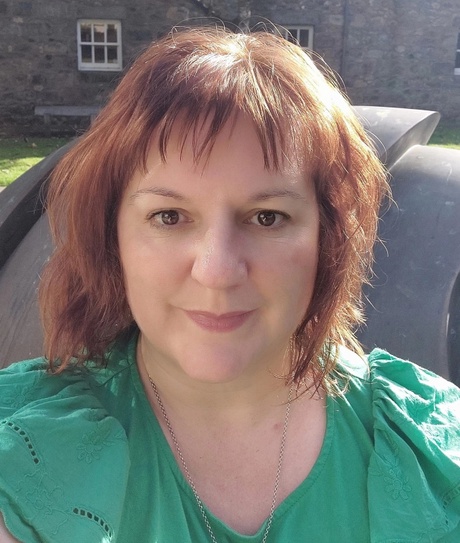 Headshot of Michelle wearing a green top