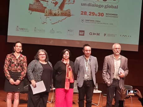 Five panelists on the stage at the conference