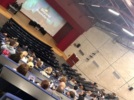 Parents and carers in a lecture theatre at Old Aberdeen with a speaker on stage at the front