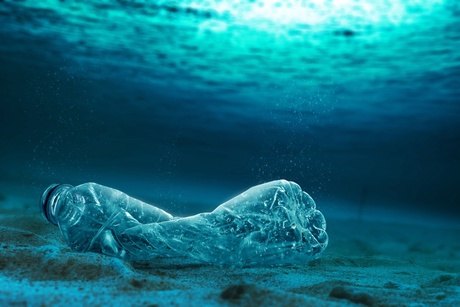 Plastic bottle lying on the bottom of the ocean