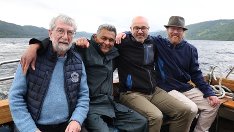 Four people sitting on a boat in Loch Ness