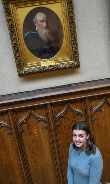 Alison Ritchie stands in front of a portrait of her great, great, great grandfather - Professor David Rennet, a professor of Maths at the University of Aberdeen in the 1800s