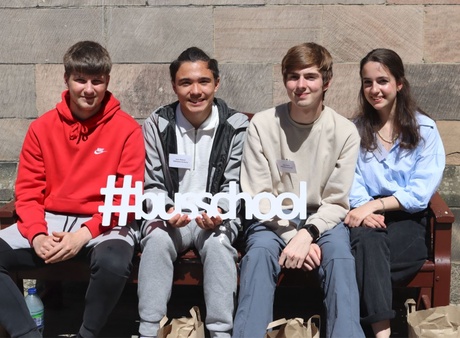 Four of the pupils sitting outside King's College