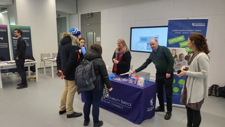 People visit one of the displays at the careers fair