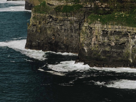 The sea and waves crashing against a rocky coastline