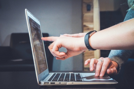 Two people using a laptop