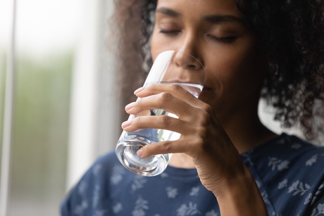 woman drinking a glass of water