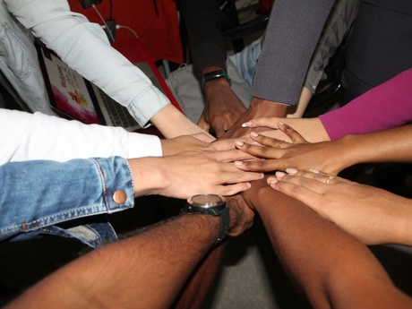 A group of people with their hands together