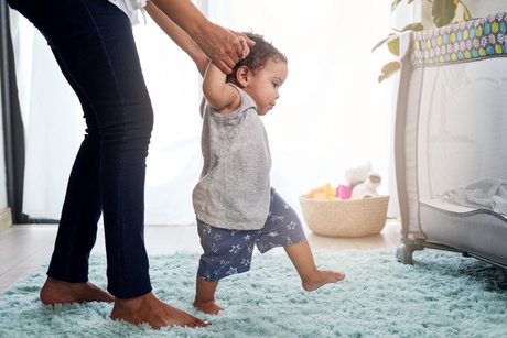 Infant taking first steps