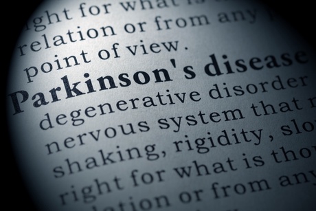 A close-up of a dictionary displaying the definition of Parkinson's disease