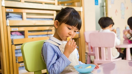 Young child examining food