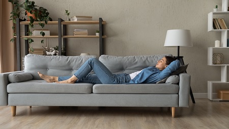 woman lying on sofa resting