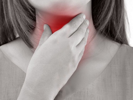 A blakc and white image of a woman touching her throat with the throat in red