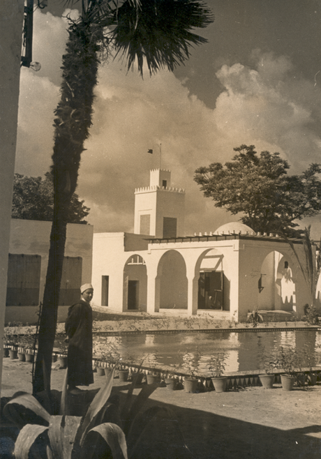 Man stands in front of pond.