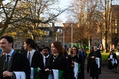 Graduands walking from New Kings towards Elphinstone Hall