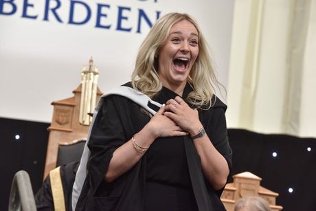 Woman smiling wide on stage