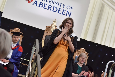 Woman blowing a kiss as she walks offstage