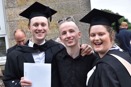 Three people smiling