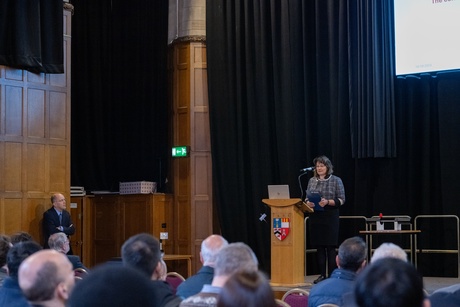 A woman on stage speaking at the 100 years of engineering event