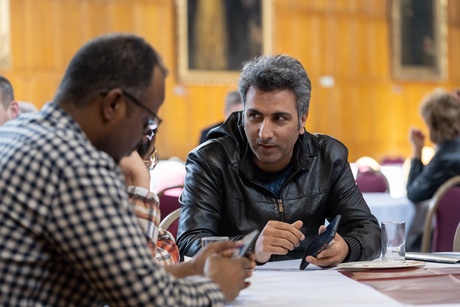 People speaking at a table