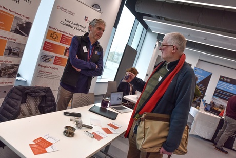 Two men speaking at the Rowett Institute stand