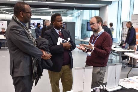 Three men speaking at the event