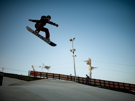 A snowboarder doing a jump at the dry ski slope in Aberdeen