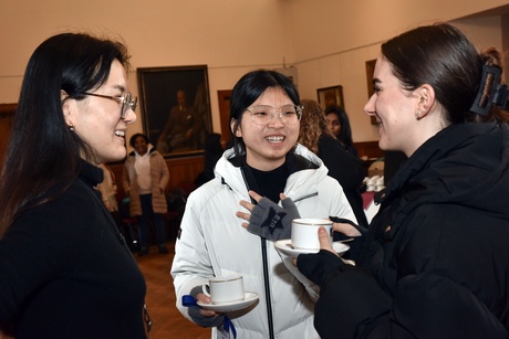 Attendees chatting with cups of tea