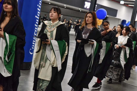 Students processing into the hall