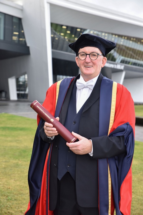 Hugh Dan MacLennan holding his honorary degree outside P&J Live