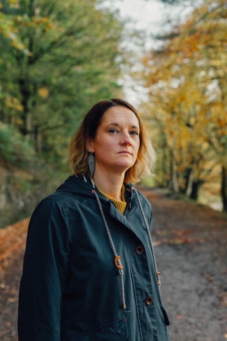 A photograph of Genevieve Carver outside on an autumnal day