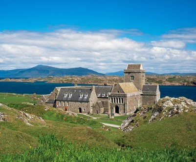 blue sky with a monastery and green hills on Iona