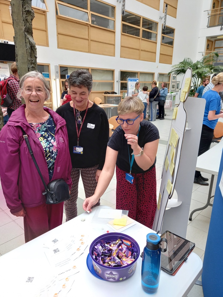 A photo of ACE staff members talking with members of the public on Doors Open Day