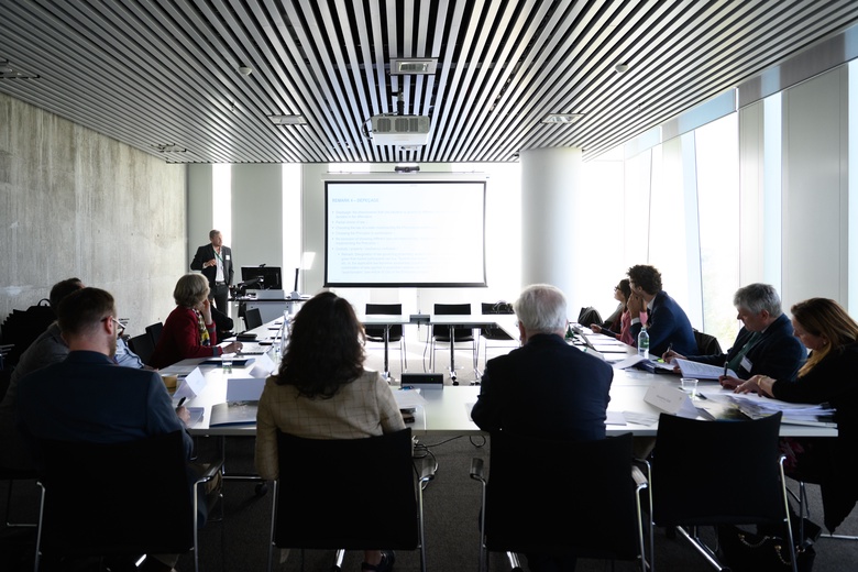 Workshop attendees in a room around a table