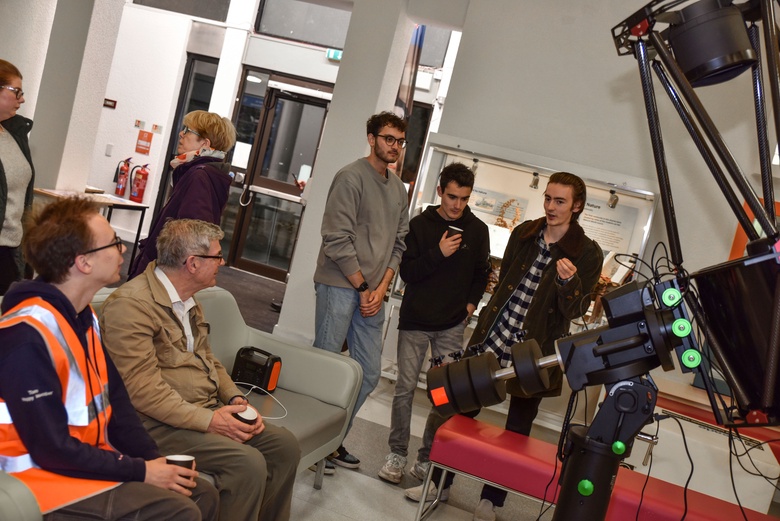 Visitors gather around the 16" telescope in the foyer of the Zoology Building