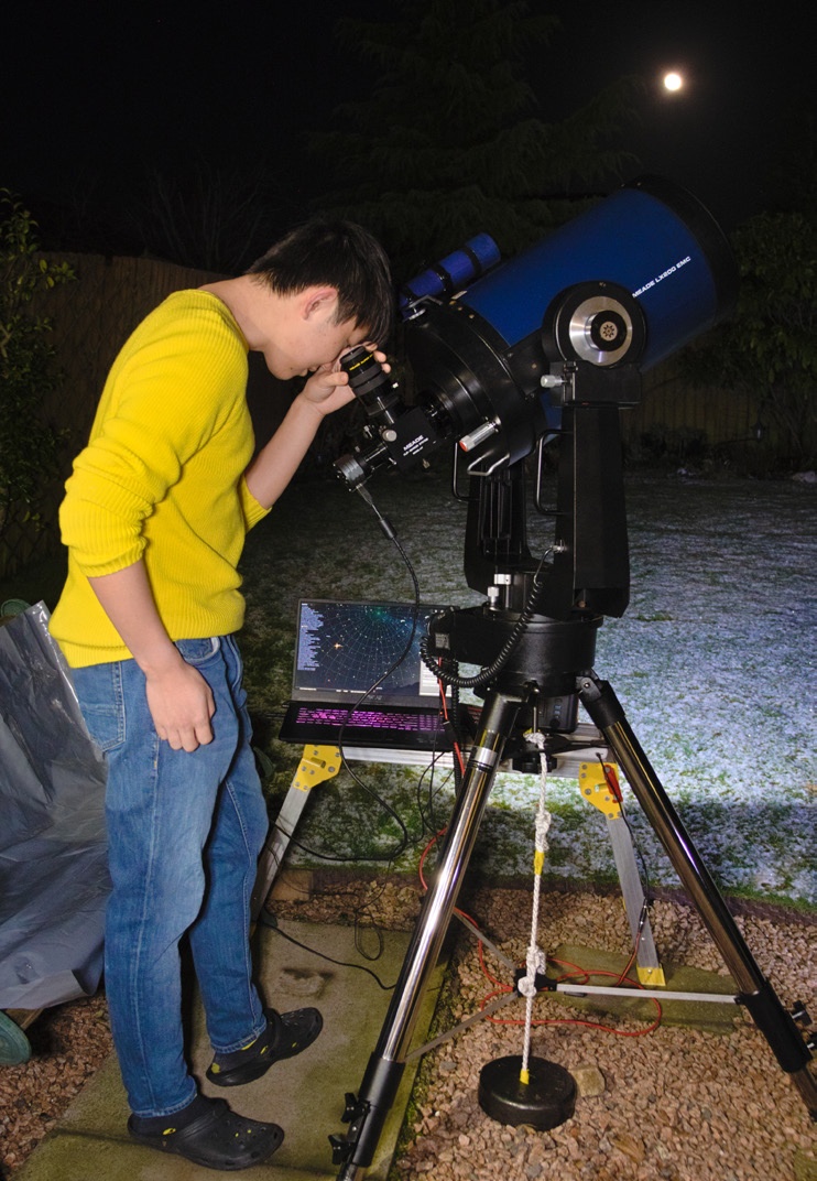 Student looking through a telescope