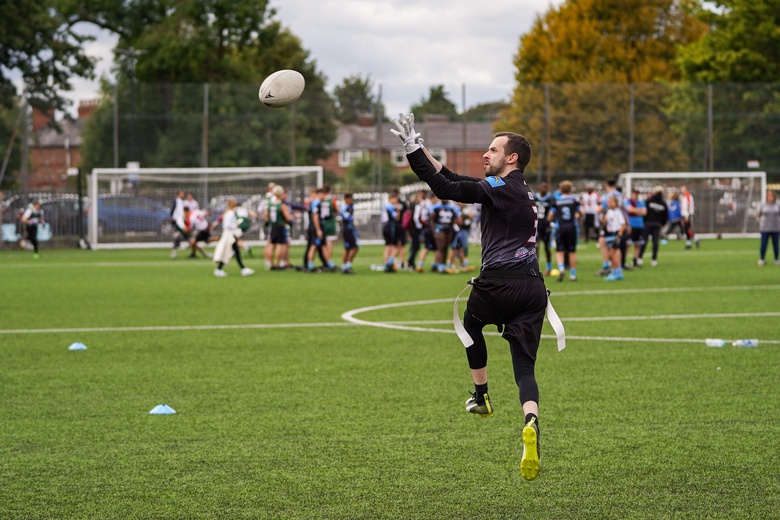 Andy on the field about to catch an American football