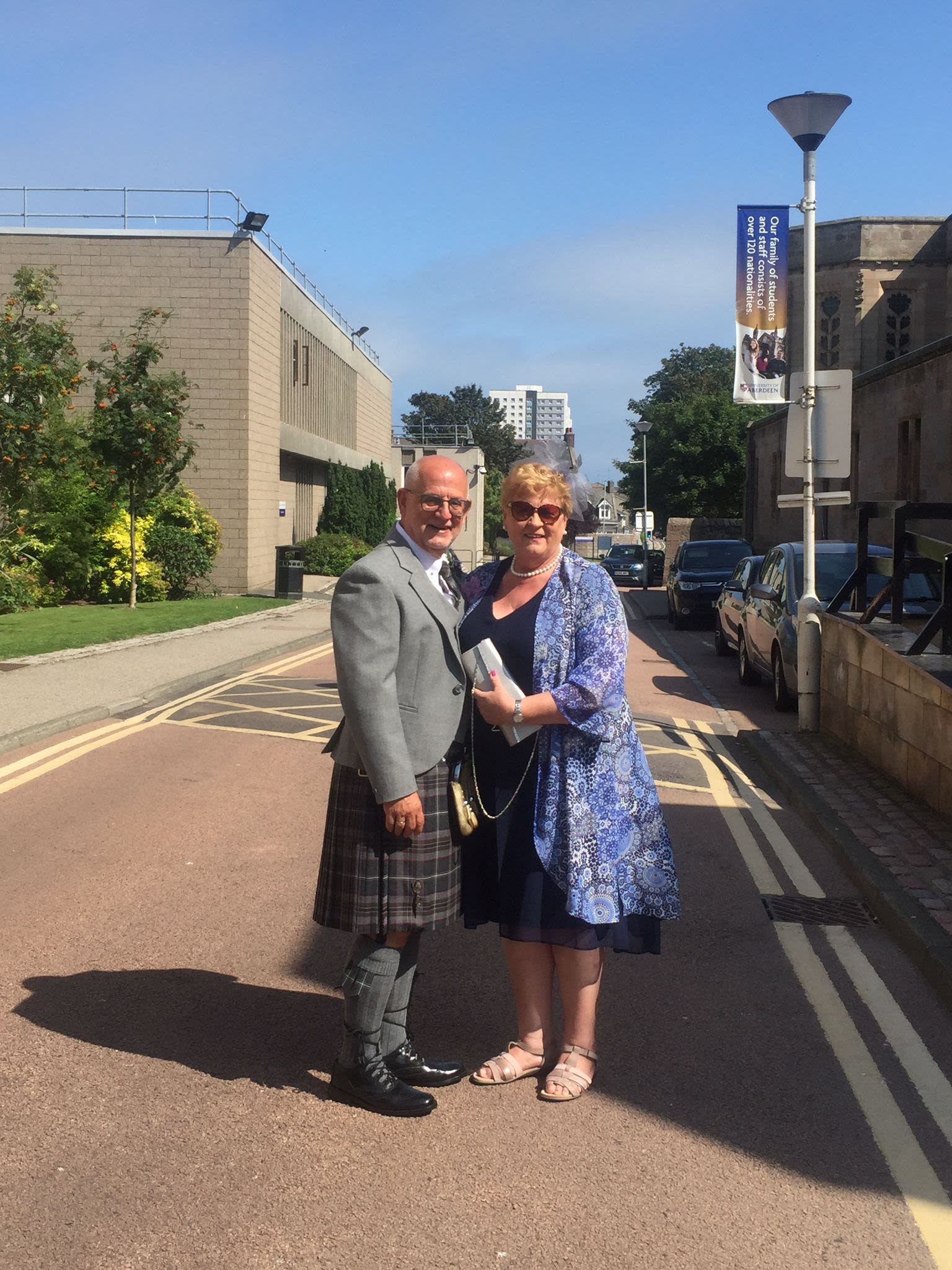 Liz and Brian standing by Elphinstone Hall